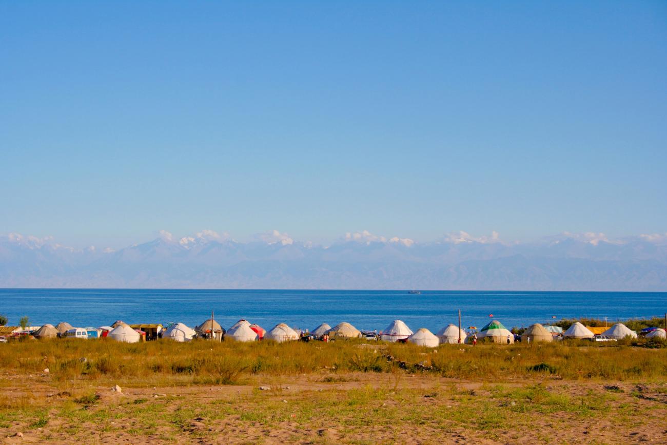 Yurts dotted along the edge of Issy Kul Lake, Kyrgyzstan